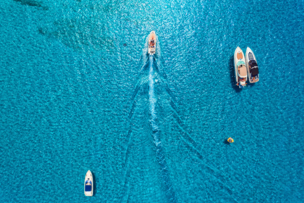 Aerial view of luxury yachts in transparent blue sea